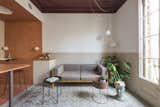 The living room post transformation has a Kettal Landscape sofa with mustard frame and mink cushions, a planter by FermLiving, and a Handvärk lamp by Studio Floor. 