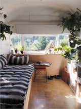 After purchasing a decrepit 1971 Airstream Sovereign for less than $5,000, Seattle-based couple Natasha Lawyer and Brett Bashaw completed a DIY overhaul of the 200-square-foot trailer for approximately $22,000. The daybed area in the front of the Airstream transitions into a small kitchen with a bathroom, while a sleeping area with a king-size bed occupies the rear.