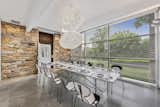 A look at the dining room in the cottage. The 30-foot-tall stone wall, which extends across multiple rooms and the outdoors, was added by the Whartons who wanted to obscure views of the cottage when inside the Shamberg House.