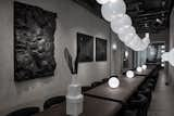 Cork dining tables are lined up in the long dining hall to create a communal setting for lunch and dinner.