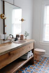 The wood waterfall vanity was built by Chris’ brother, Jeremy, who used oak wood reclaimed from an old barn that was then sanded down and finished with water-based polyurethane.