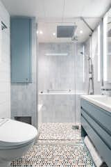 The guest bath features Artistic Tile stone mosaic flooring and walls of Ann Sacks Blue Celeste Field tile and Stone Source Luce Di Ceramica Pumpkin tile.