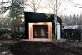 While the idea of a motorcycle shed might not initially scream "elegant she shed," there's a lot to love in this shed by Drop Structures. The exterior lighting gives the building a presence at night, and the mixing of natural wood, a white door, and darker cladding make for simple but modern exterior.