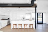 Sitting on a spot that provides a commanding view of the ocean and hills beyond, this California home underwent a major renovation of the kitchen after the homeowners purchased it in foreclosure. A new entry space was created out of an unused hallway and the glazed door and side panels let in even more light, and the all-white kitchen with white countertops and cabinets features an oversized sink.