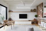 Living room with low built in units maximises sense of height to new living space, while shelves provide ample spaces to display client's wonderful collection of African artefacts 