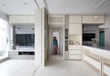 The original living room was converted into an open-plan kitchen and dining area with a living room that can be reconfigured into a bedroom. The use of natural materials and the large windows that flood the space with natural light and frame the views make the small space feel bright and airy.