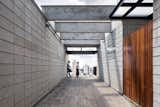 The pergola on the "promenade" entrance to the upper level residence frames views of the city and hints at the expansive balcony through which the home is entered.