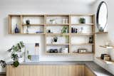 The built-in timber storage units in the living room feature the same concrete top as the kitchen bench and the desk in the study nook. The rawness of the concrete contrasts with the refined oak timber joinery and minimal white walls.