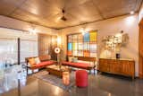 The private family sitting room on the first floor overlooks the atrium above the dining space through a colored glass screen that matches the one on the ground floor. Bamboo screens provide a “buffer” against harsh sunlight.