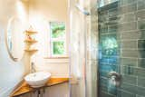 A Hawaiian mango wood counter and shelving add texture and warmth in the bathroom.