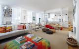 Clever arrangements of furniture delineate the spaces in the loft’s open floor plan. In the living area, a hand-knitted Donna Wilson Motley ottoman sits opposite a B&B Italia Charles sofa and Arco lamp.  