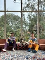 Josh Jessup (left), Louis the dog and Matt Moss, pictured in their rental home's "conversation pit."