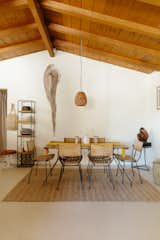 Portmans styled the dining area with a vintage table and set of chairs by Arthur Umanoff. The shelving unit, also by Umanoff, sits near a 1957 Tulip Stool by Eero Saarinen for Knoll.