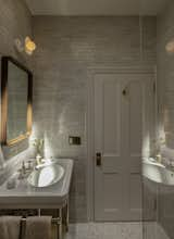 Like the kitchen, the bathroom has similarly tight quarters, but with a skylight overhead, it is drenched in light. 