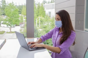 a woman looking at a laptop