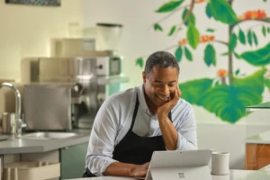 Restaurant owner keeping working at desk. Microsoft 365 and Surface. Small business owner. Male, food, coffee, restaurant, Covid, pandemic, inventory.