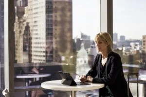 Business woman at table with Surface.