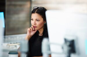 Woman concentrating at a workstation.