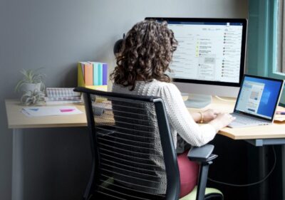 a person sitting at a desk in front of a computer