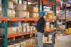 A person with a tablet in a warehouse