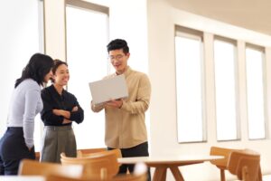 Team collaboration around a laptop in an office