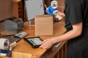 Customer service employee fulfilling, packaging and shipping online orders in the storeroom.