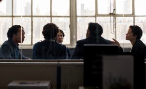 Five people participate in a meeting.