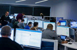 Group of people sitting at desks working in an office.