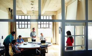 Image of four coworkers collaborating in an office.