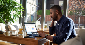 Image of a remote worker working at his desk. An Excel spreadsheet is open.