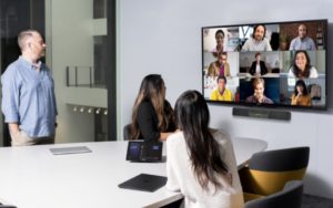 Image of a team on a Microsoft Teams meeting featured on a big screen