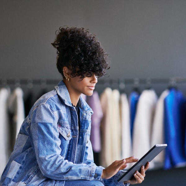 Empowered retail employee in focused work on tablet screen with data powered by Azure.