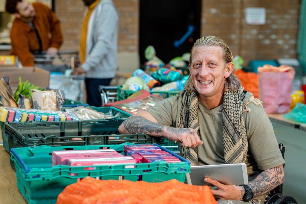 A nonprofit volunteer collecting donations of food and clothing