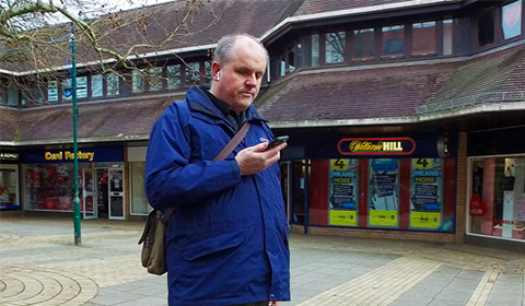 a man standing on a sidewalk