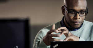 Image of a man looking at his laptop.