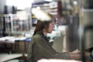 Decision maker creating a survey or taking a security assessment on the warehouse floor of a textile manufacturing plant.