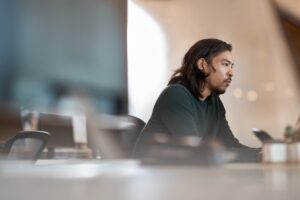 Enterprise office worker in focused work with a neutral facial expression.