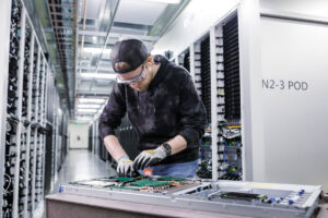 Datacenter service technician working on server rack