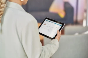 A woman looks at a tablet.