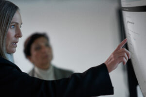 Chief information security officer collaborating with a practitioner in a security operations center