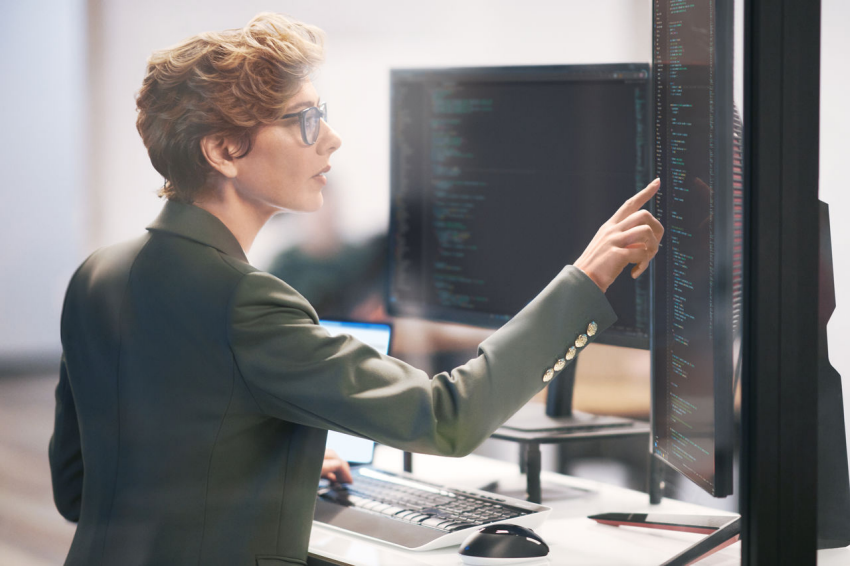 Woman using two monitor screens