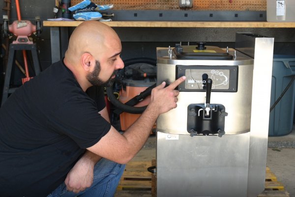 iFixit teardown tech Shahram prepares to open an ice cream machine