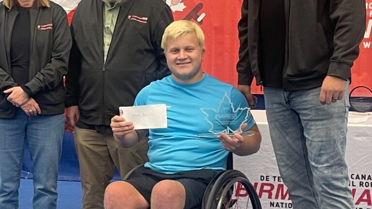 Thomas Venos holds up a trophy at the Birmingham Nationals, Canada's wheelchair tennis national championships.