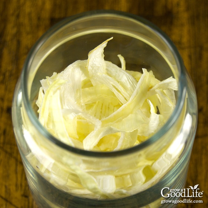 overhead photo of dried onion flakes in a jar