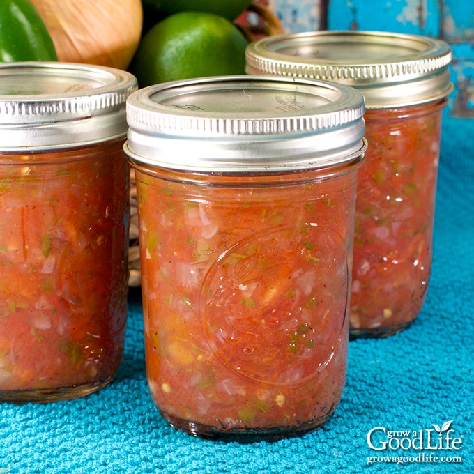 half pint jars of jalapeno salsa on a blue towel