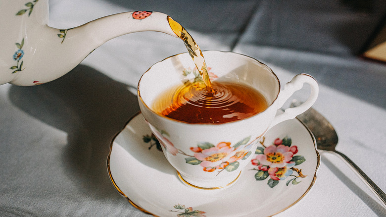 Tea pouring into cup