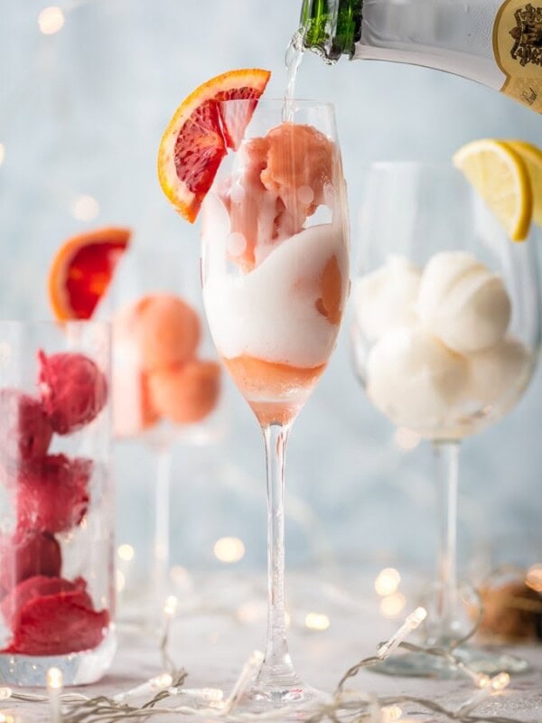 This is one of the BEST MIMOSA RECIPES for any brunch. It would even make a great dessert cocktail.  Sherbet Mimosas are a fun and creative way to dress up any mimosa recipe! Use the ice cream, sherbet, or sorbet flavor of your choice and mix with champagne. It's so fun, delicious, and beautiful! It's the perfect cocktail recipe to make for holidays, bridal showers, and beyond.