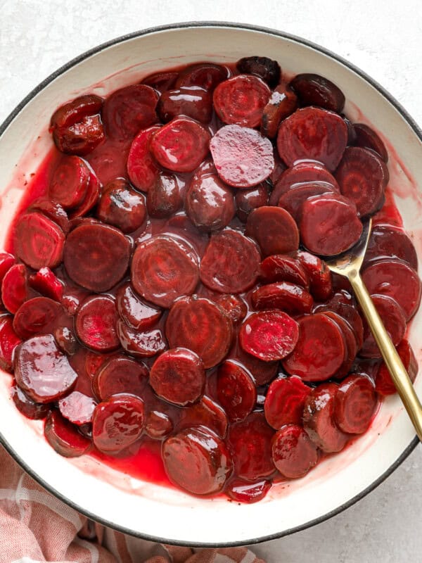 Harvard beets in a pot with a spoon.