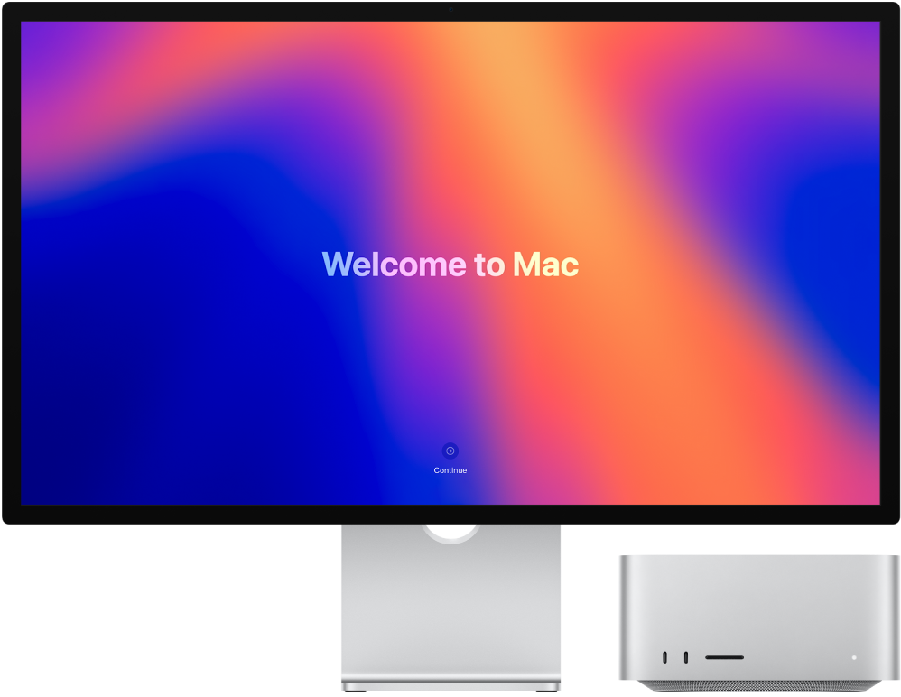 Studio Display a Mac Studio vedle sebe. Na monitoru je vidět text „Vítá vás Mac“.