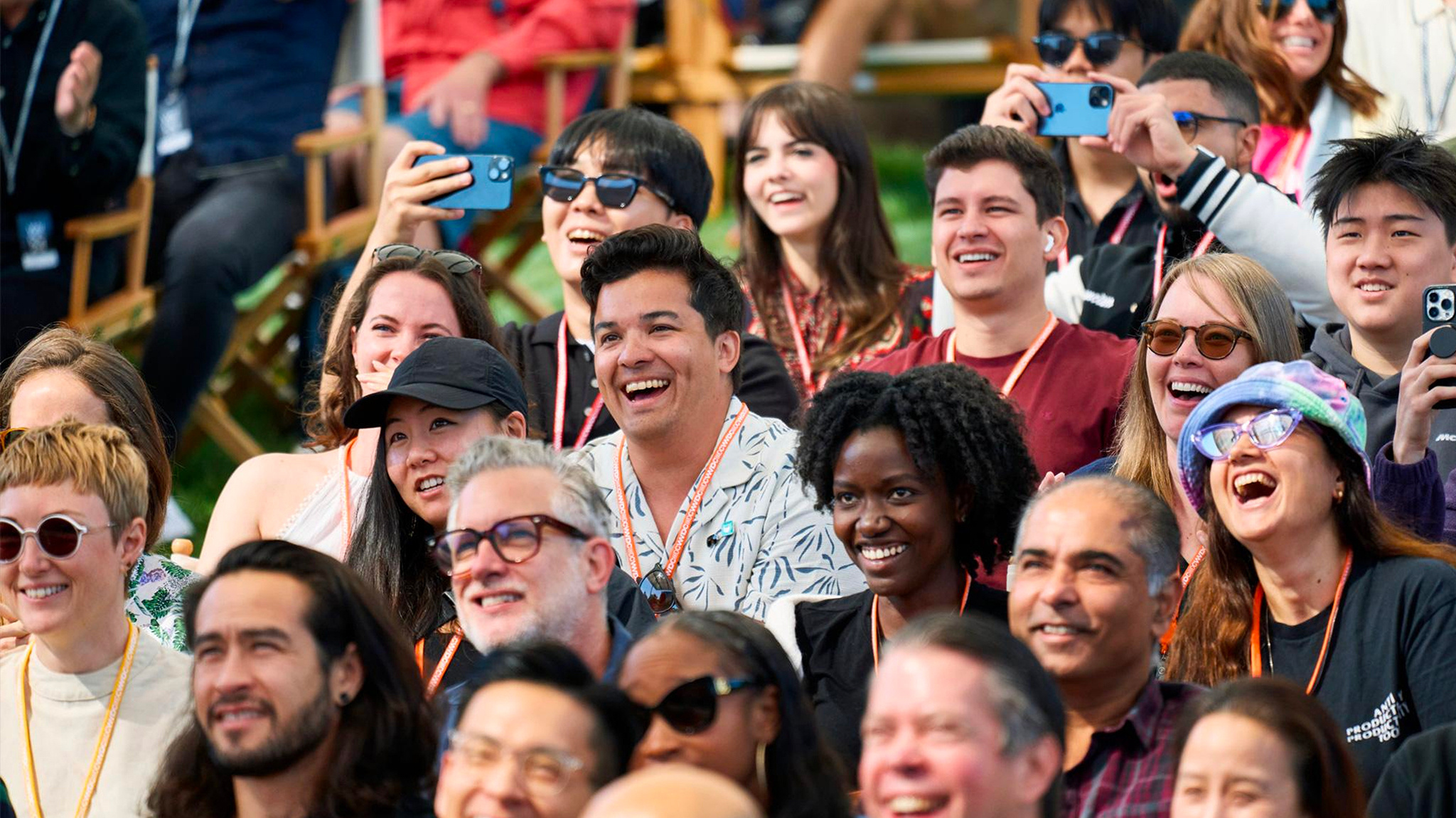 People sitting in a group outside laughing.